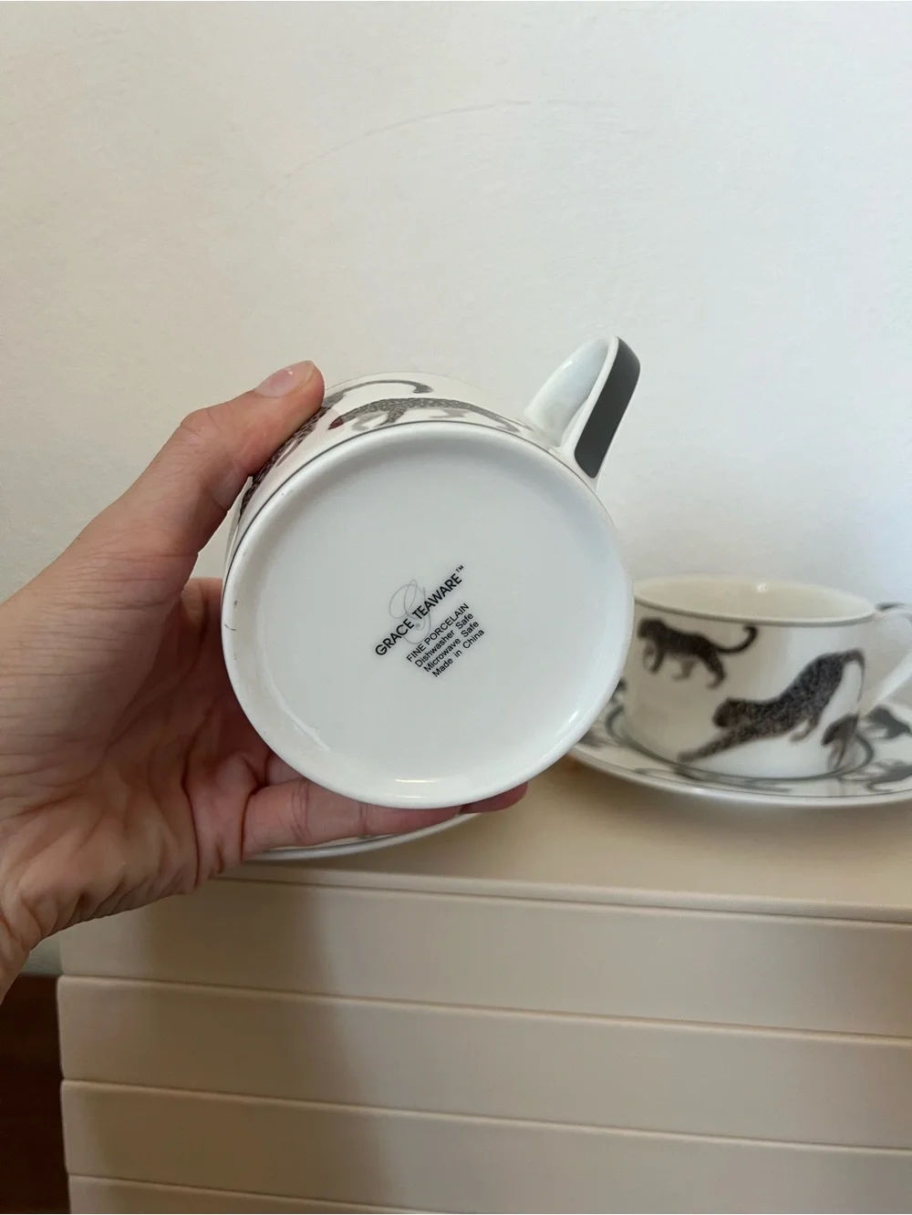 Cup and saucer set with black leopard print on white background